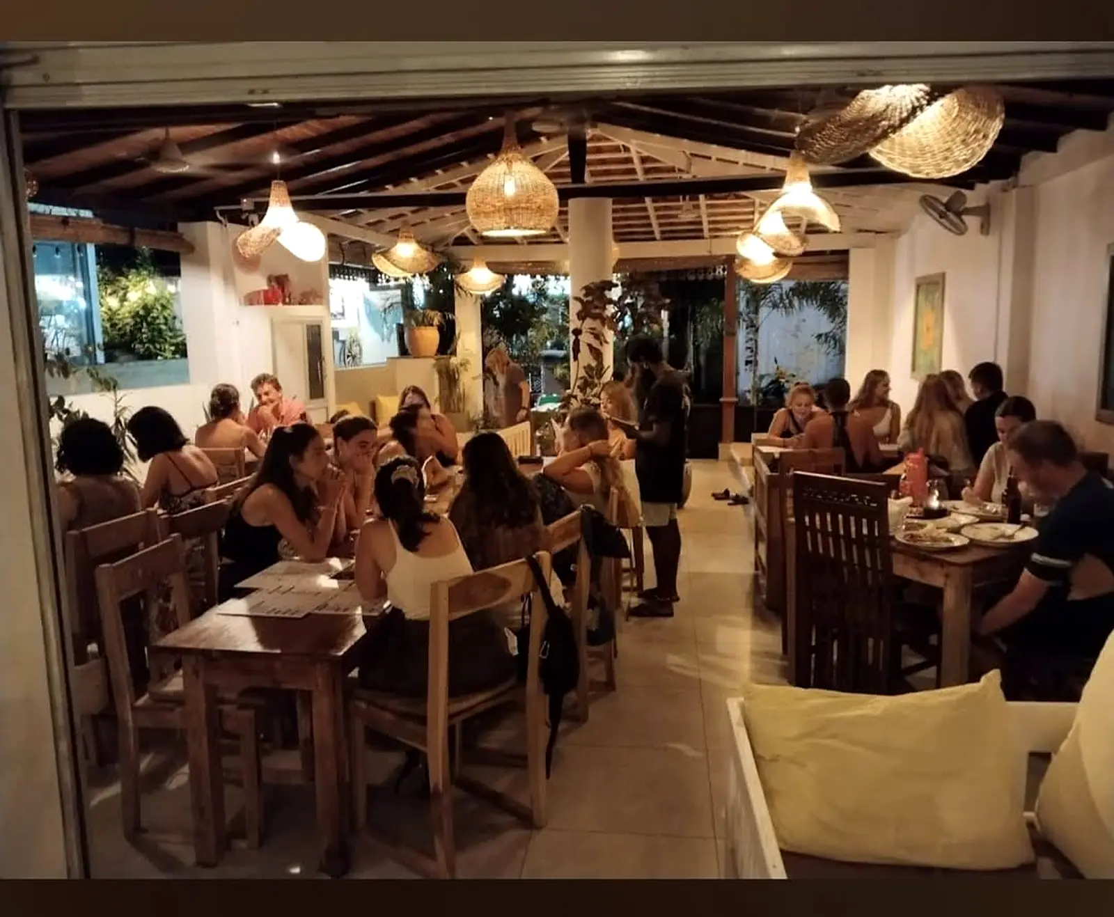 Evening service at Pink Elephant, Unawatuna, with warm lamp light over the tables