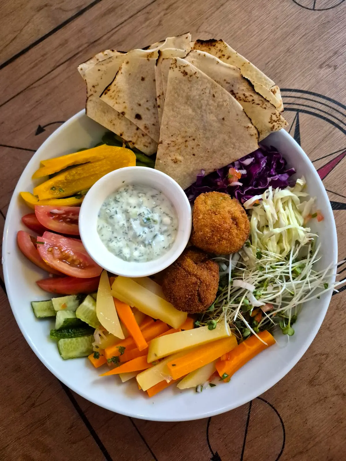 Falafel platter with flatbread, yoghurt dip, grilled vegetables and fresh salad